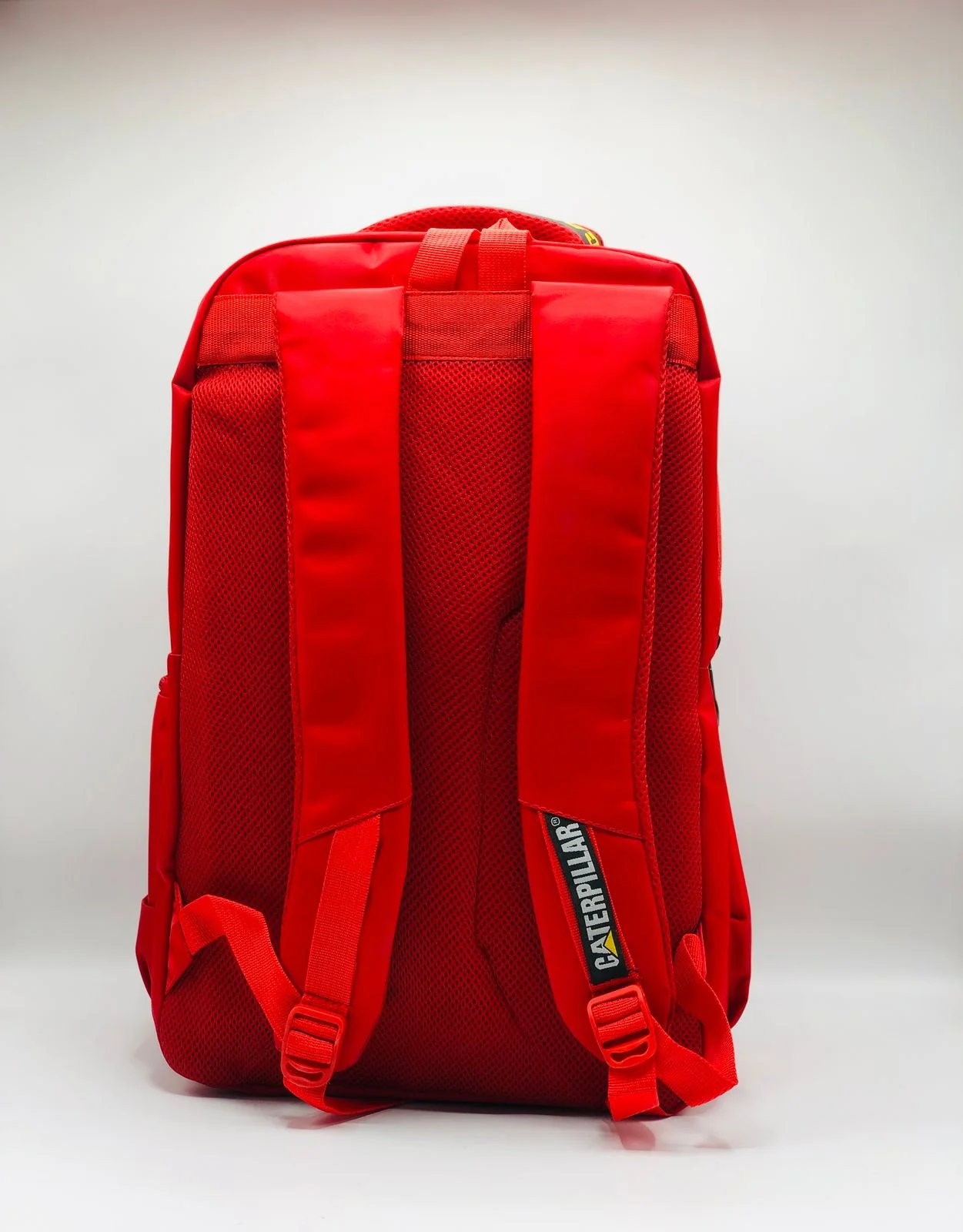 Durable Caterpillar Red School Backpack featuring a bold red design, spacious compartments, and strong stitching, ideal for everyday school and travel use.