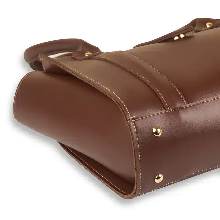 Coral chocolate handbag with dual-tone design and structured elegant finish