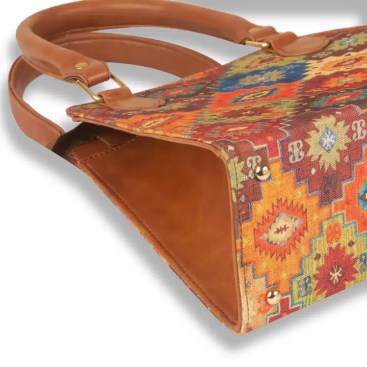 Artistic multi-color handbag with structured shape and organized interior
