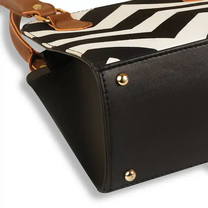 Black and white handbag with minimalist design and compact structure