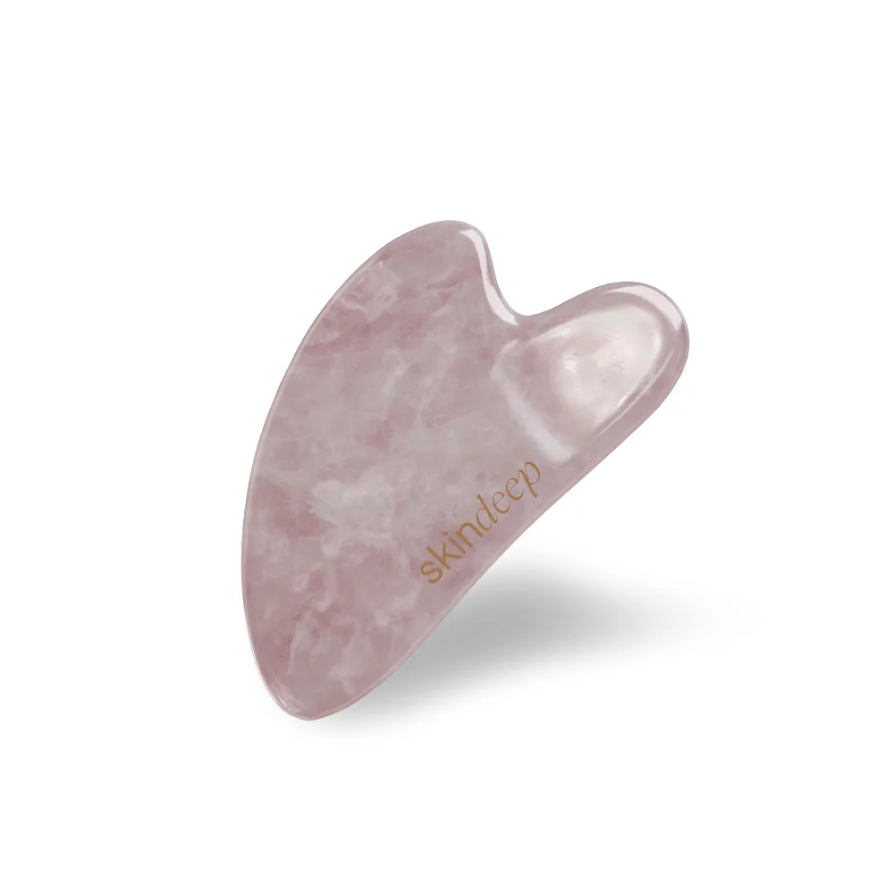 Side view of skin deep rose quartz crystal heart gua sha tool